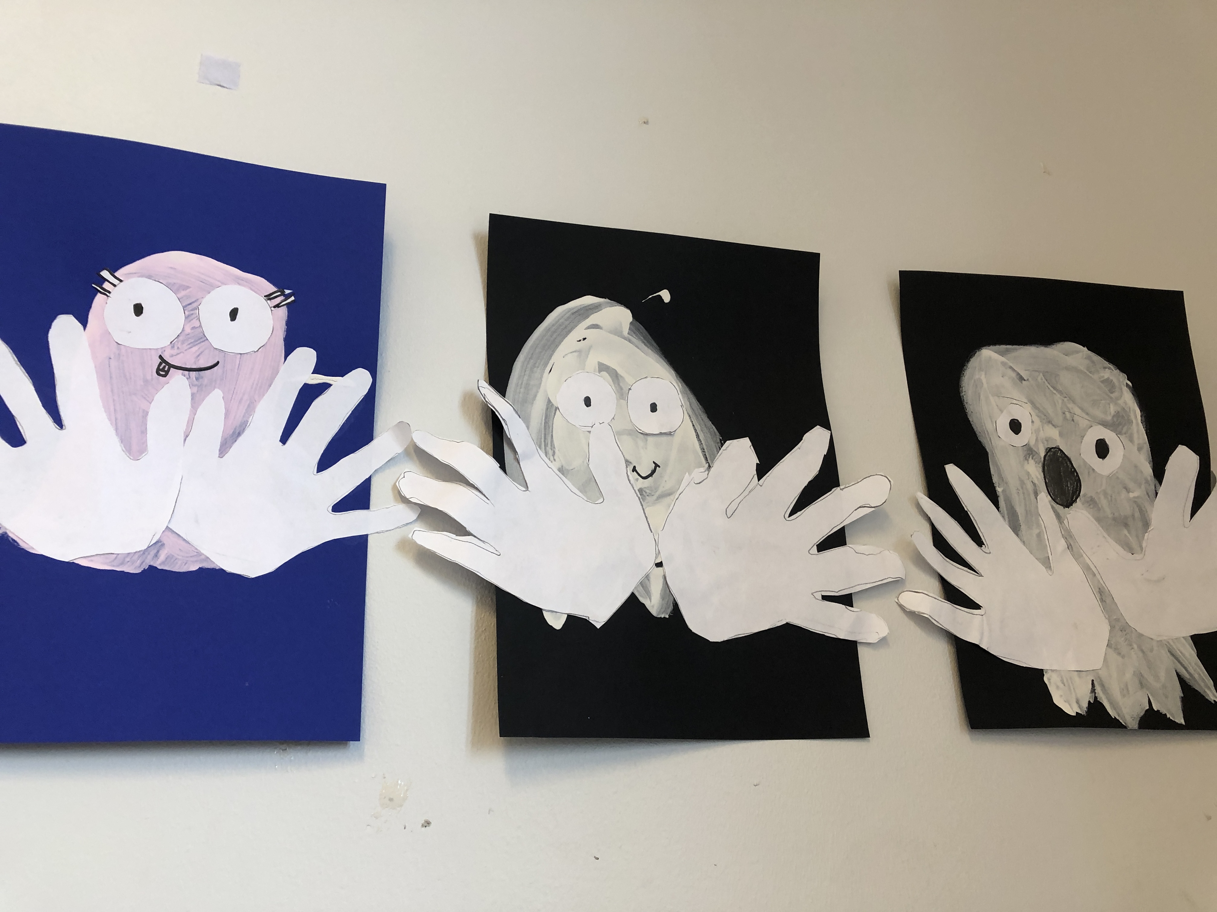 En gruppe tegninger på en hvit vegg